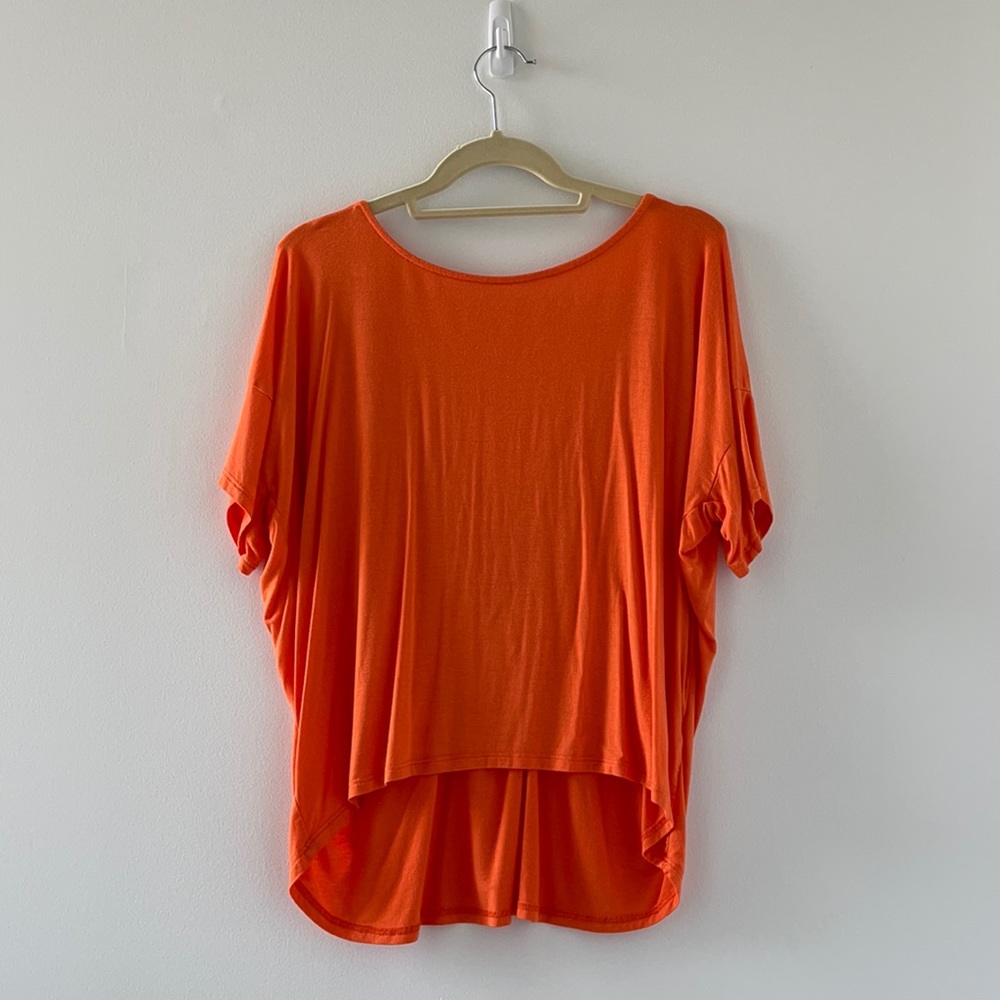 orange blouse with low crisscross styled back